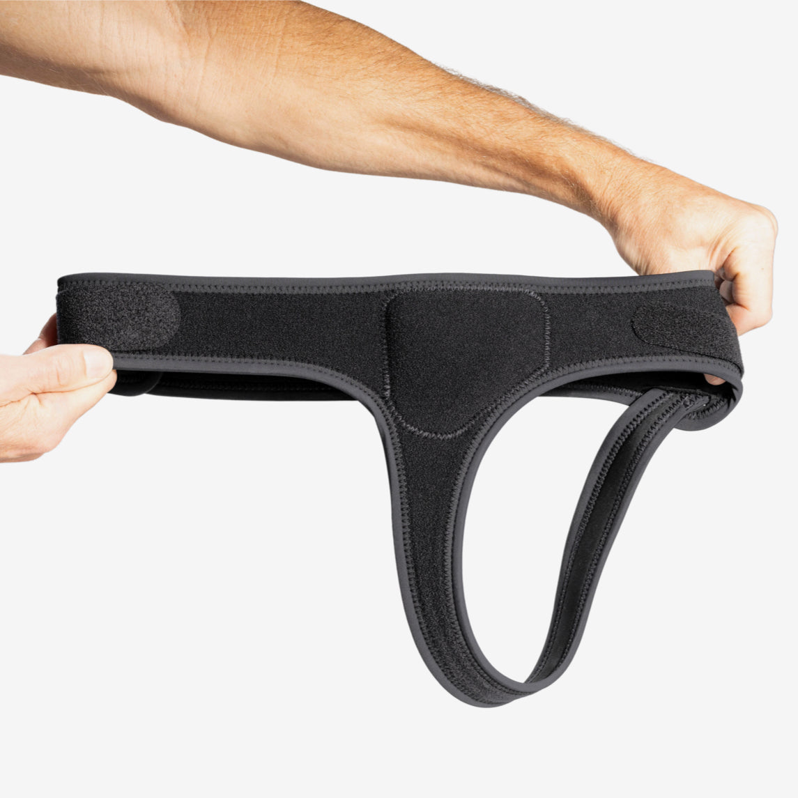 Hands holding minimalist single side hernia belt